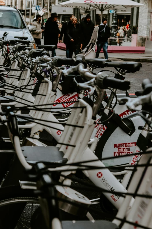 bikes and people standing in a line on a busy street