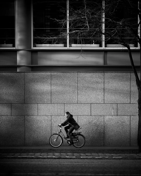 a person is riding a bike near a tree