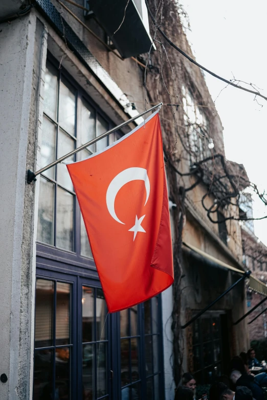 a turkish flag hanging outside of a shop