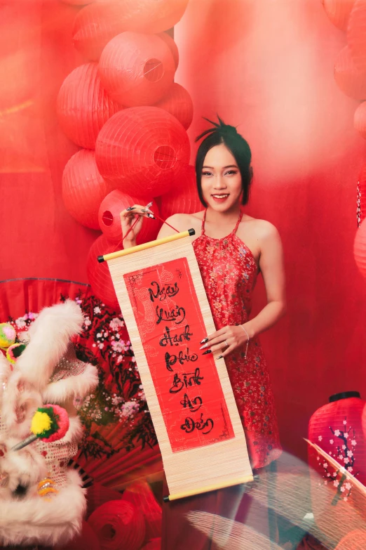 a woman standing next to a display of pink and red items