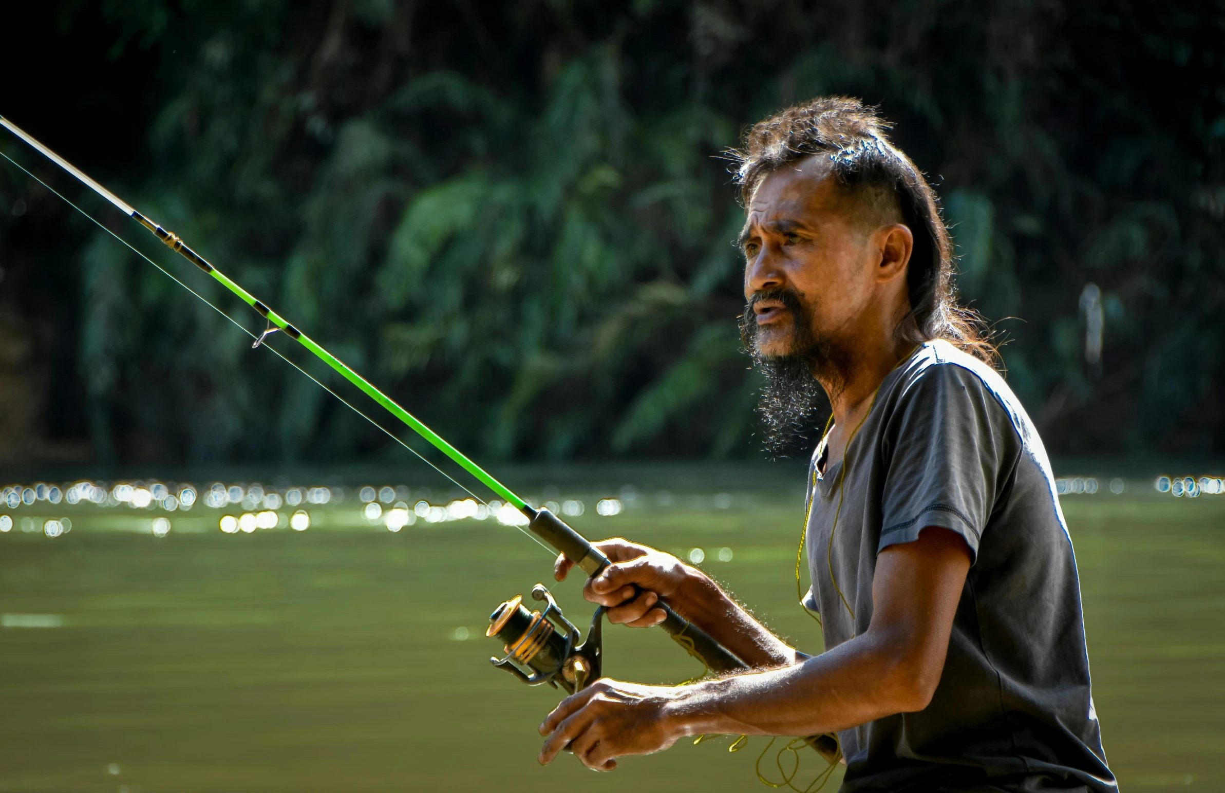 the man is fishing on a calm river