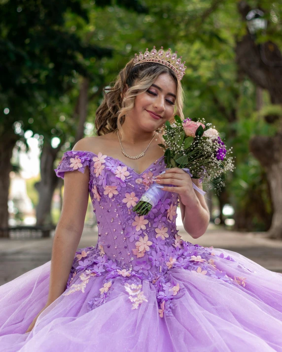 a pretty lady in a purple dress holding flowers