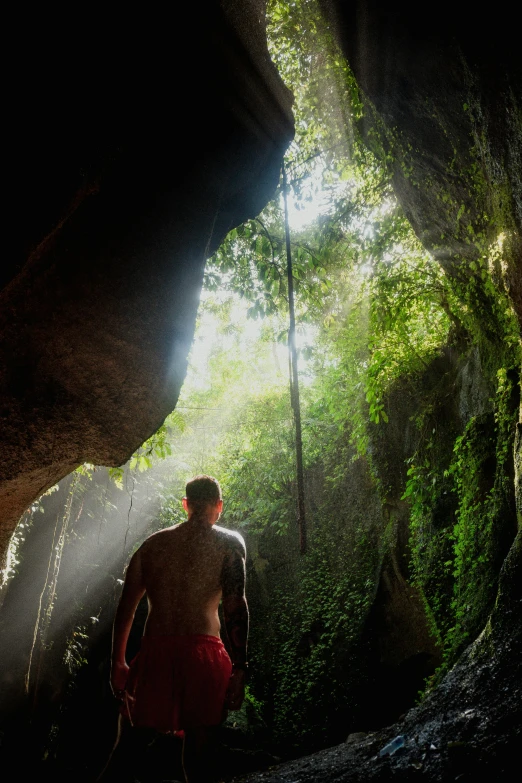 a man is standing in the light coming through a tunnel