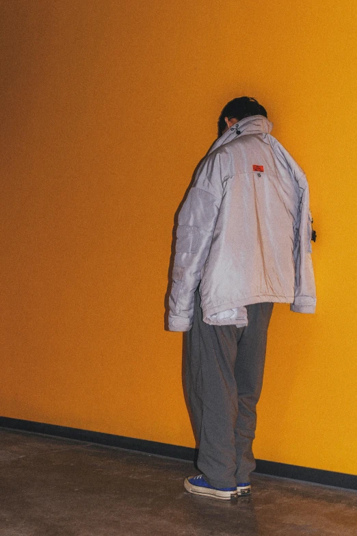 a person standing on a tiled floor in front of a wall