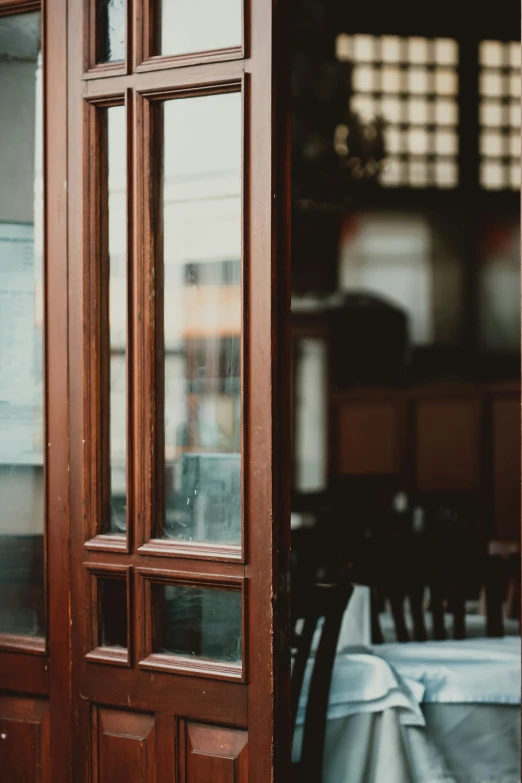 the windows and doors to a restaurant and tables