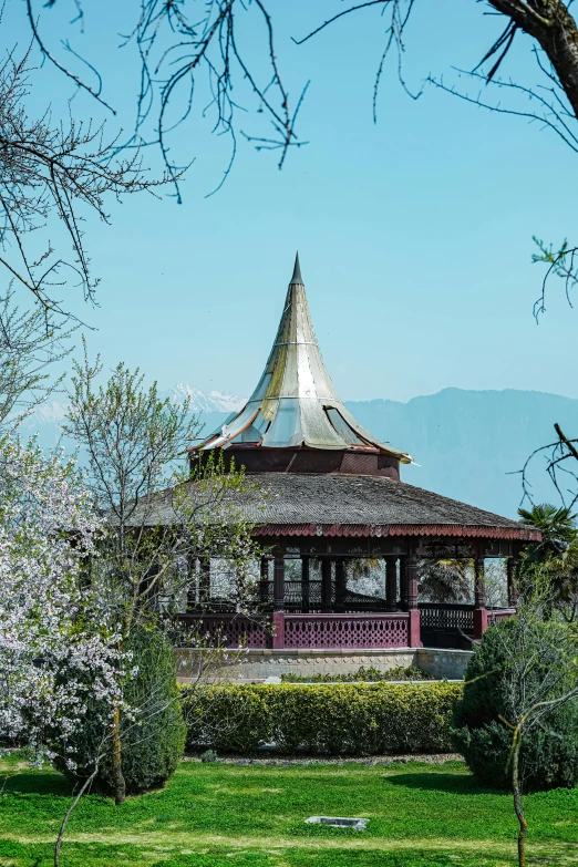 a large red gazebo sitting under a blue sky