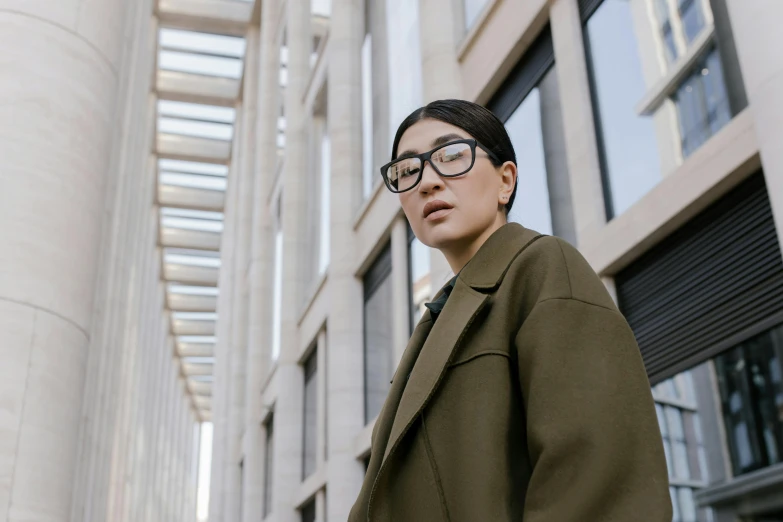 a young man wearing glasses poses for the camera