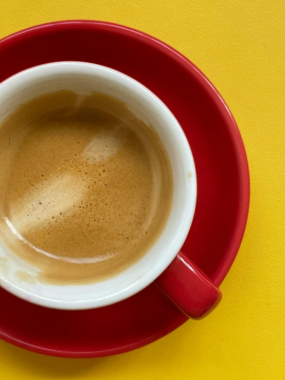 an overhead view of a cup of coffee on a saucer