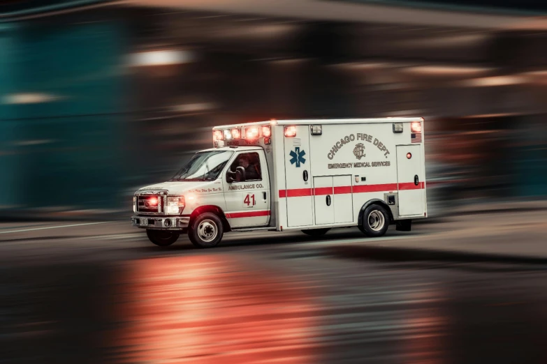 an ambulance drives through a city street