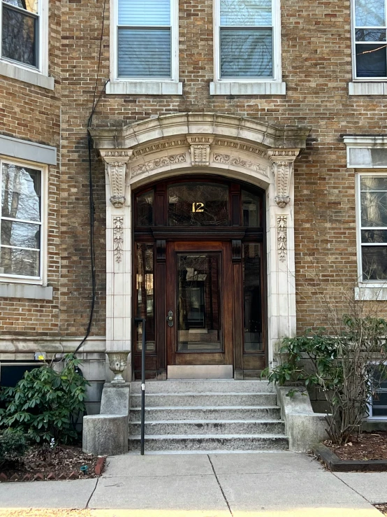 a building with two floors and a door and stairs