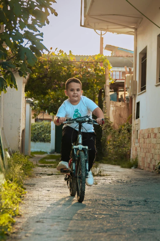 the  is riding his bike through a narrow path