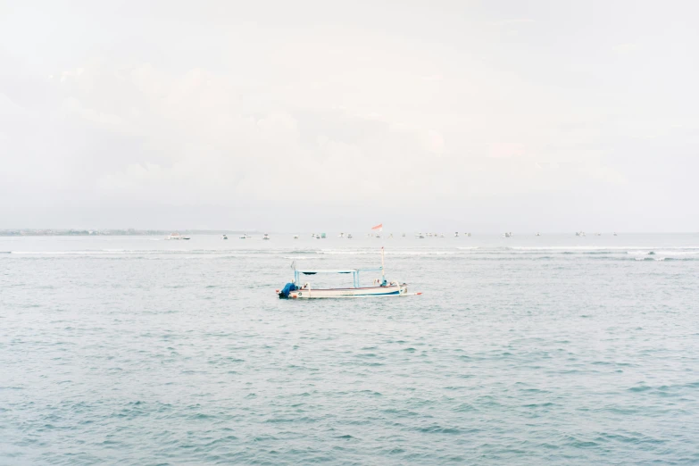 a boat on the open water and some sailboats