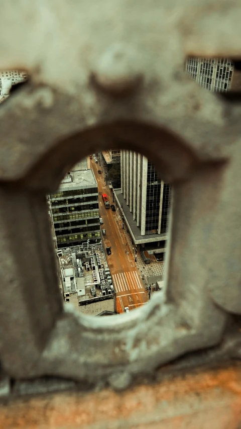 a city seen through an iron fence from above