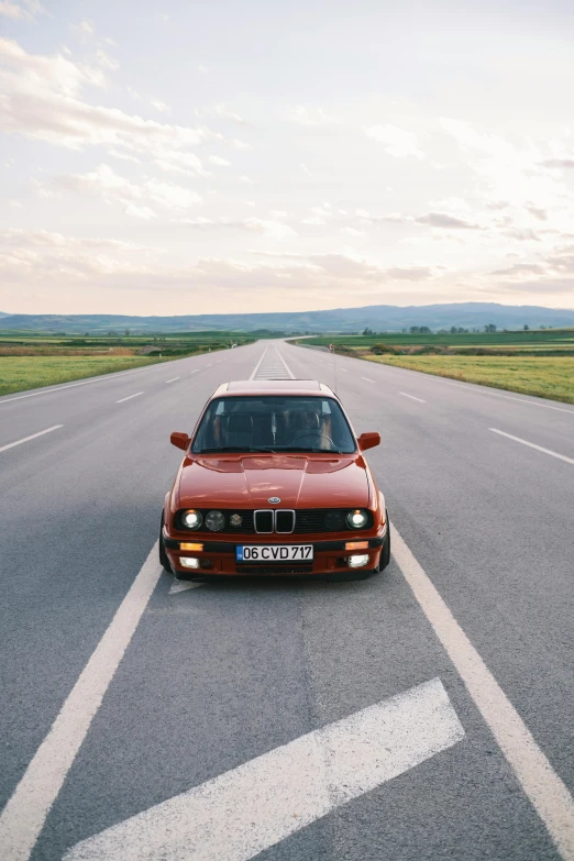 a red car driving on the road