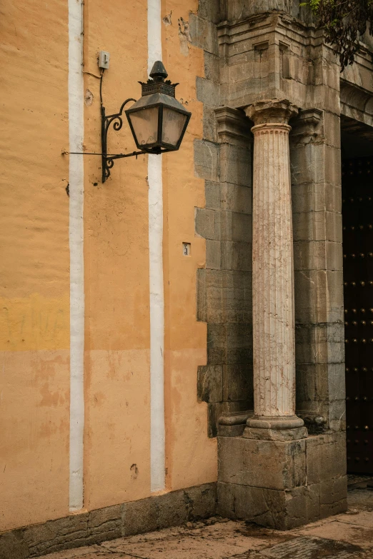 a lamp that is on the side of a building