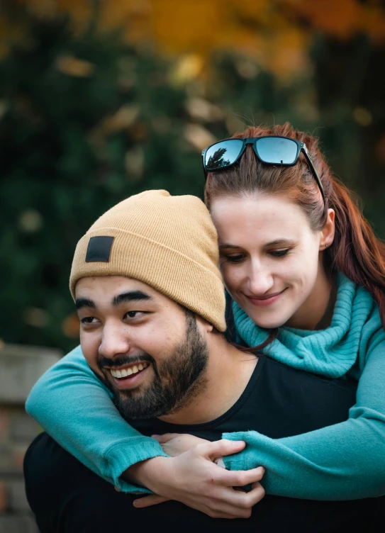 a man and woman hugging while they hold each other