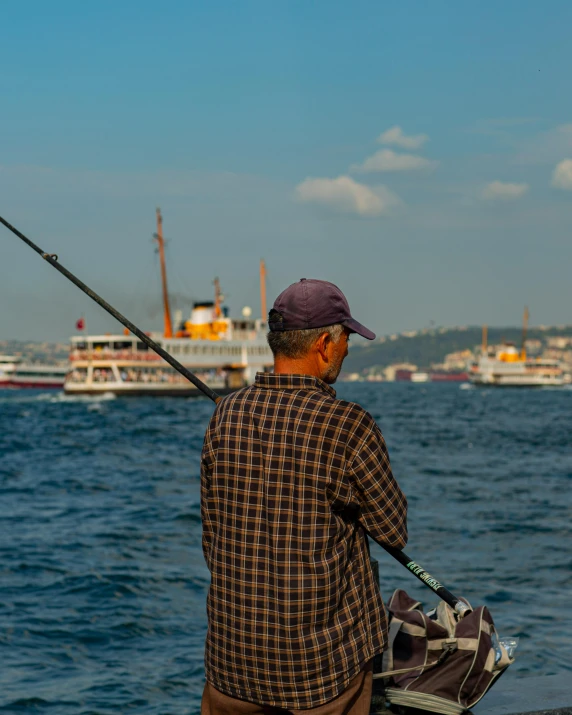 an old man is fishing in the water