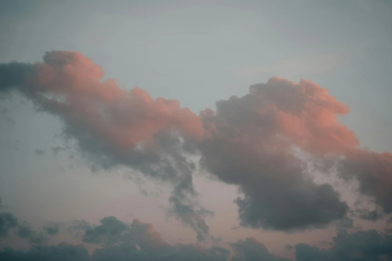 pink clouds in the sky on a foggy day