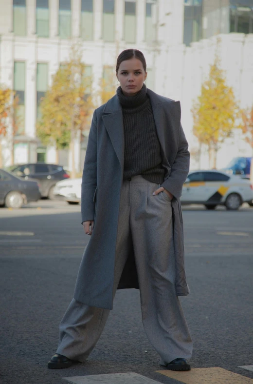 woman wearing grey suit and black turtle neck sweater