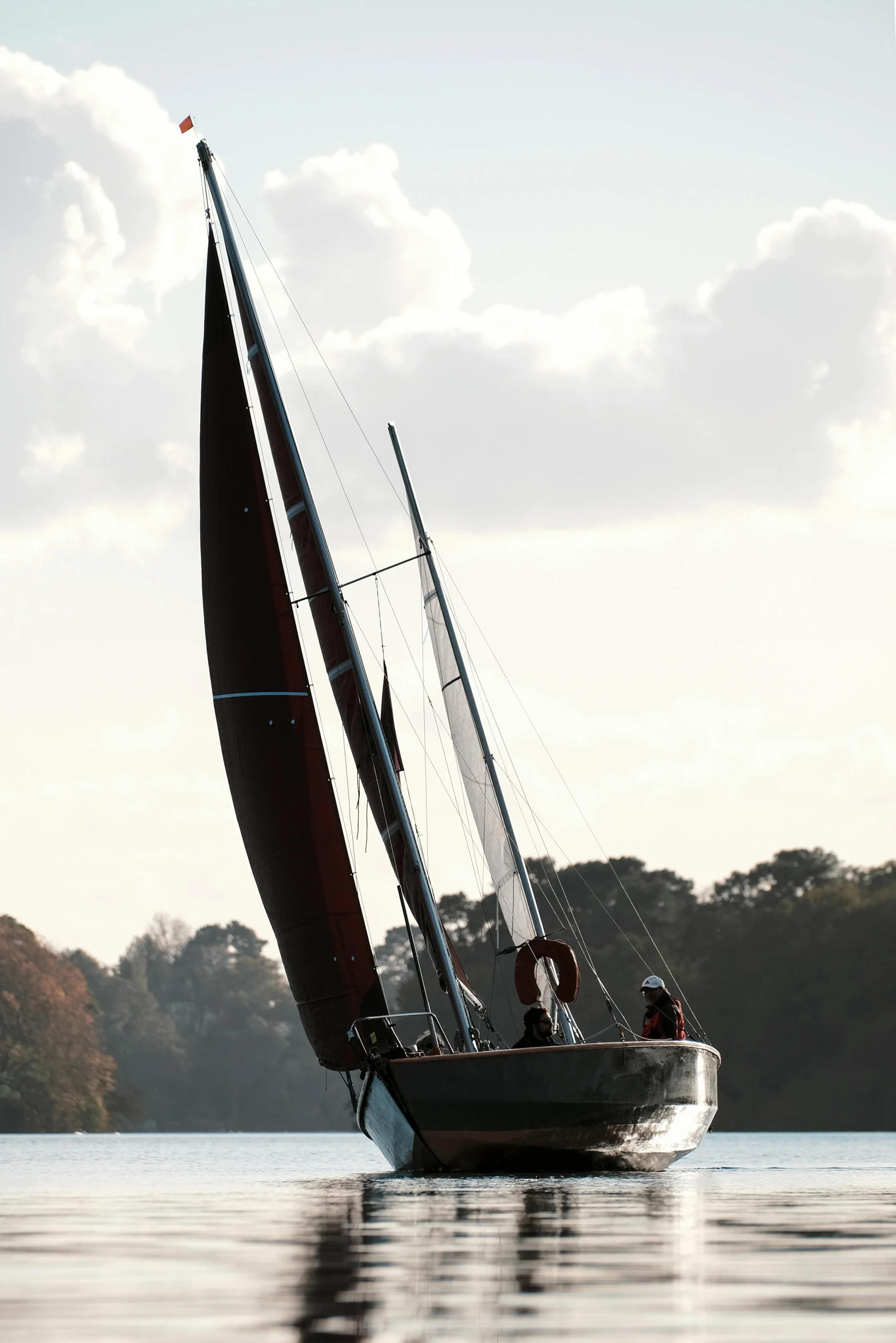 a sailboat sailing on a lake during the day