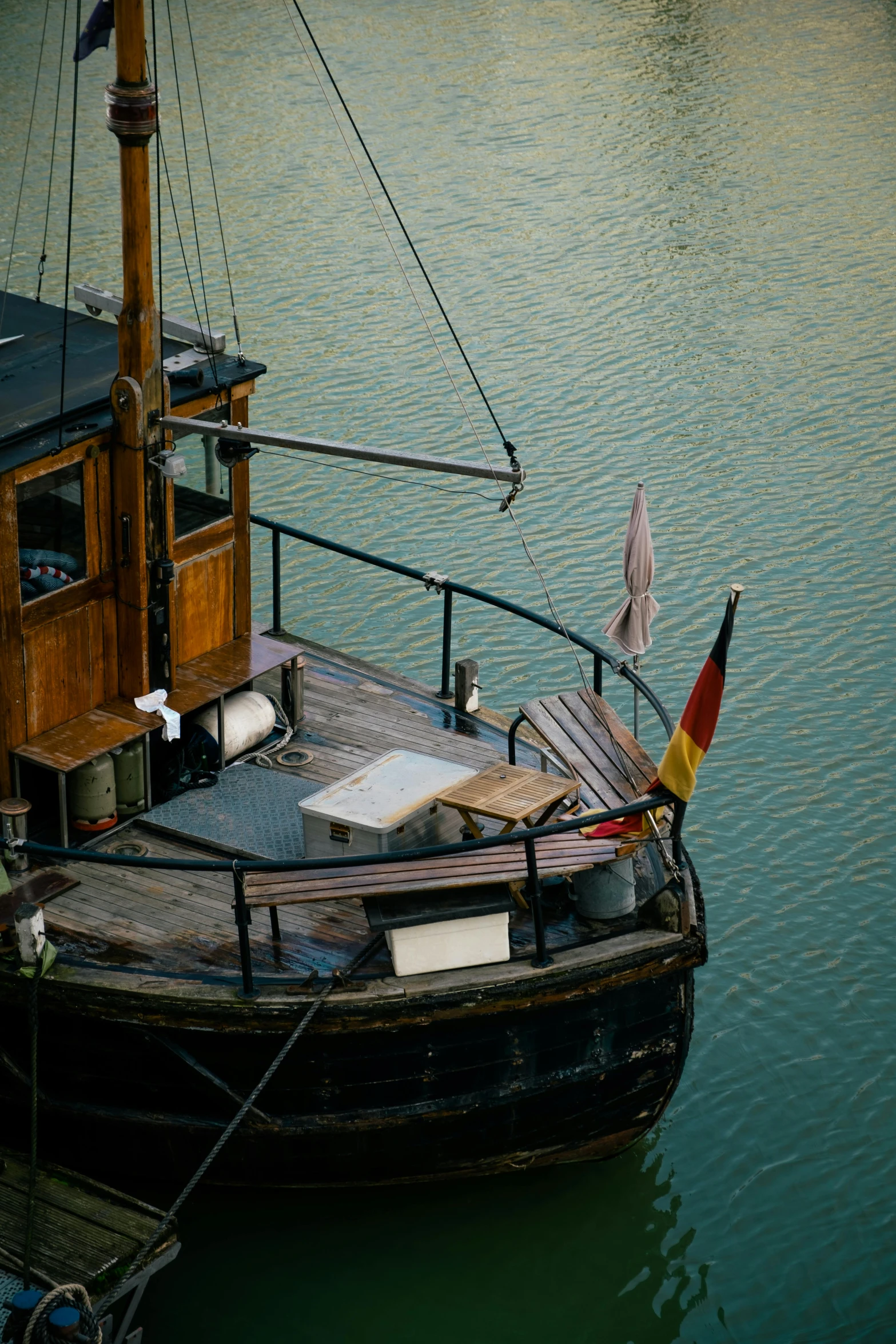 a small boat docked on top of a lake next to a pier