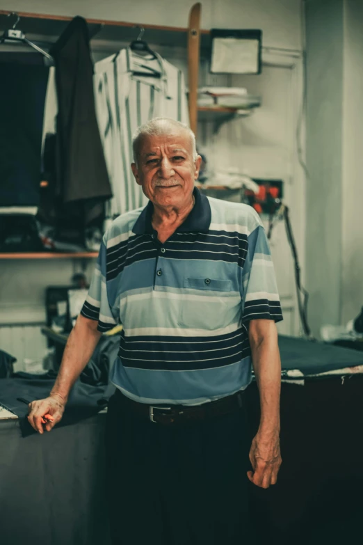 an old man stands in a store posing for a picture