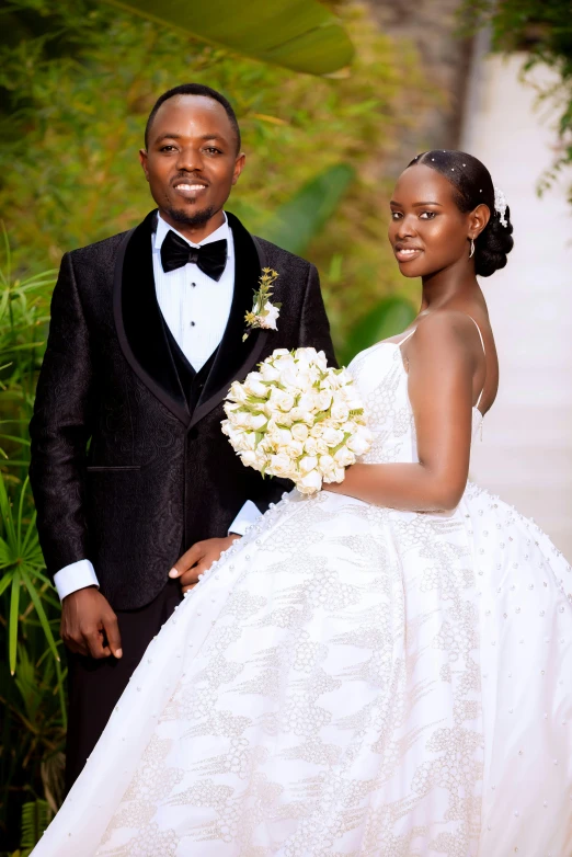 a bride and groom pose for their wedding po