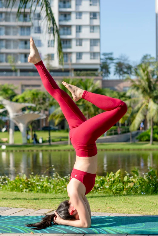 a woman is in a yoga pose outdoors