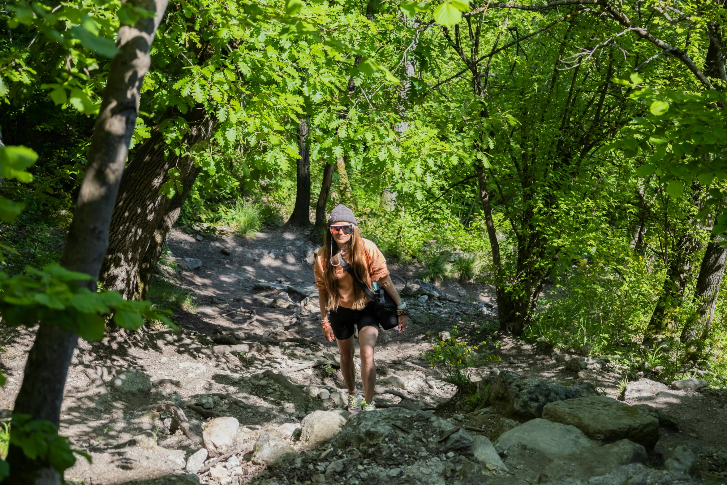 a man in shorts walking through the woods