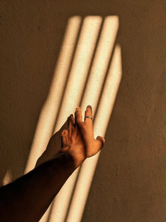 the shadow of a hand and a persons arm