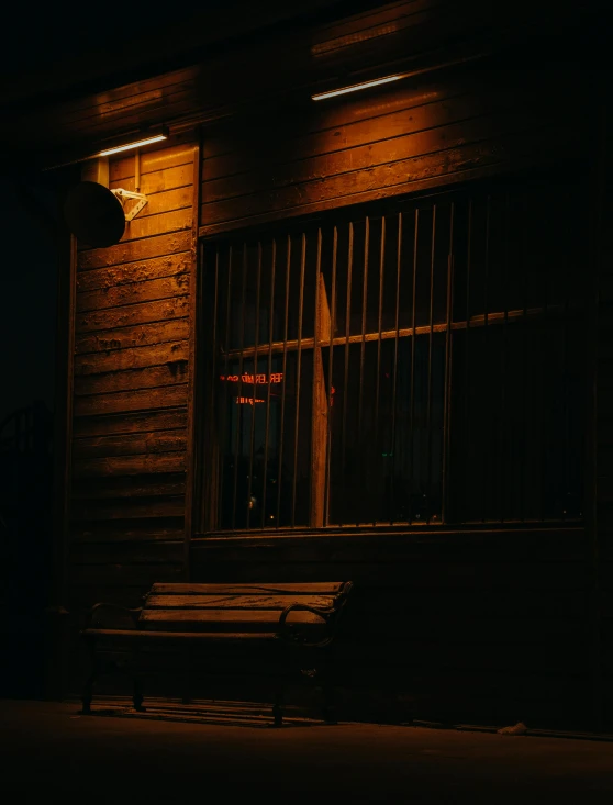 a church that is next to a window lit by a cross