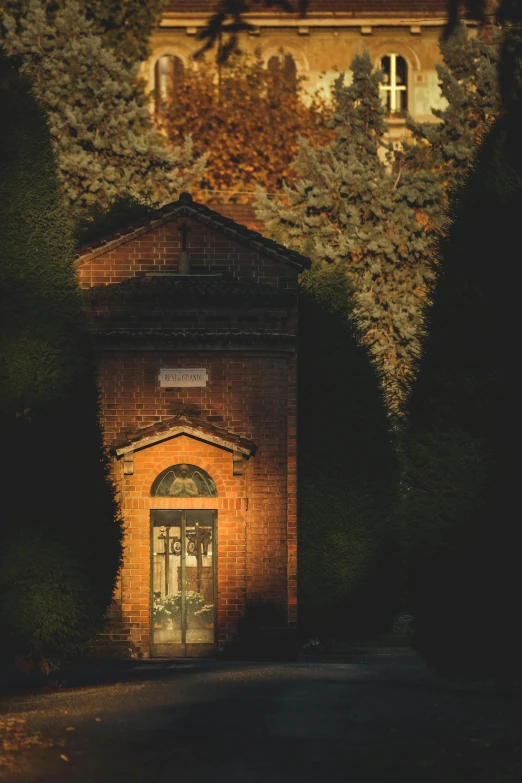 a brick building is shown at night with the moon in the distance