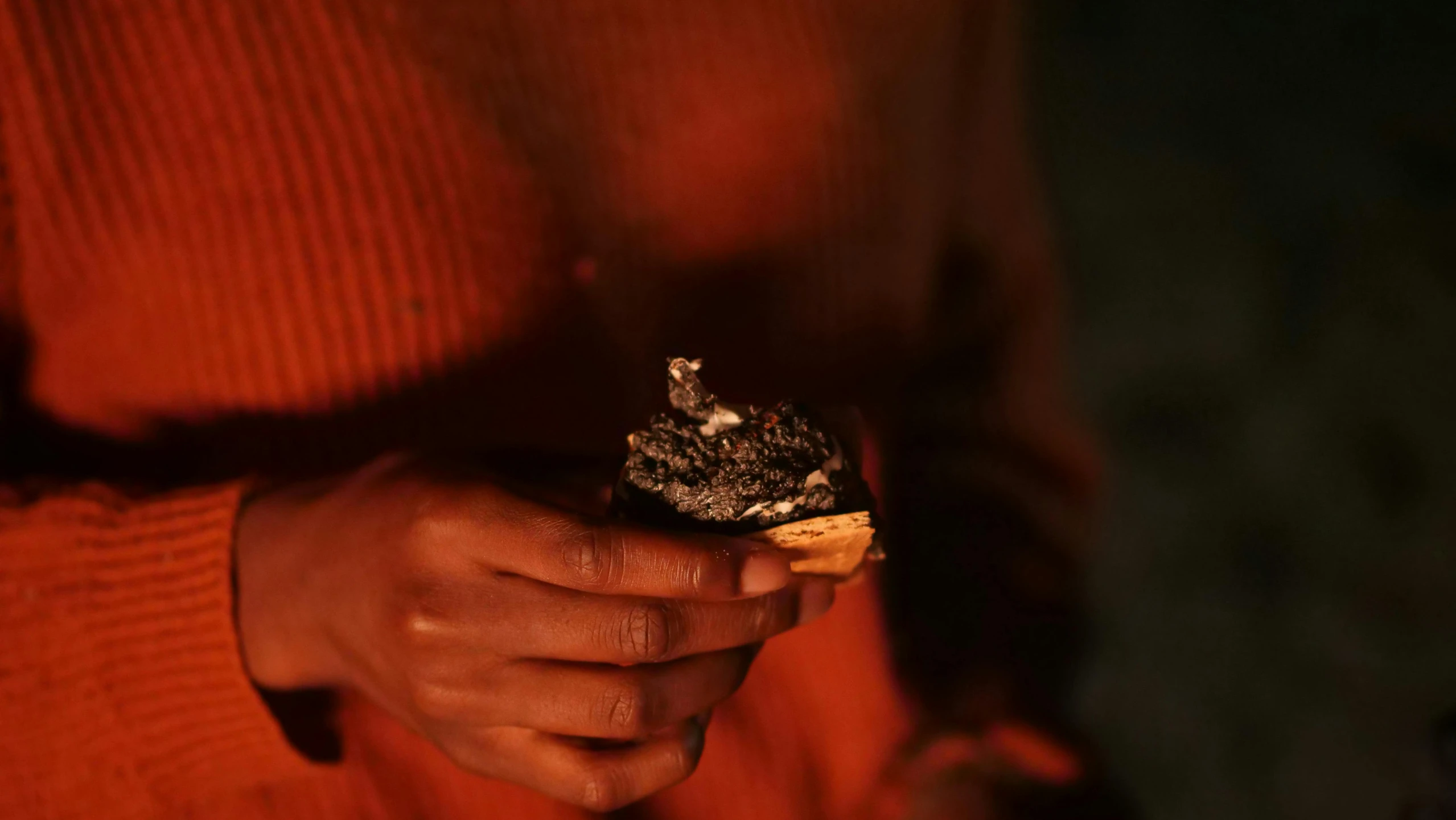 a close up of a person holding food in their hands