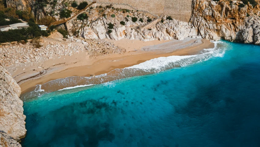 an aerial s of the sandy beach and cliffs