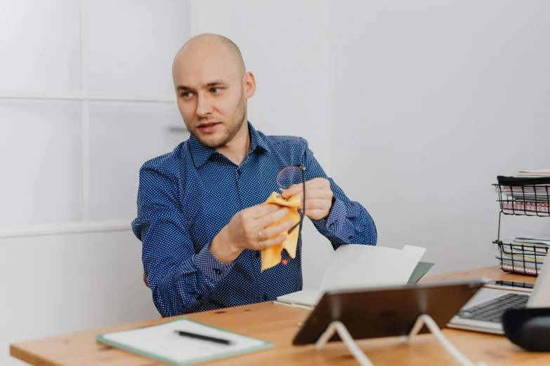 a man is sitting at his desk and  into soing