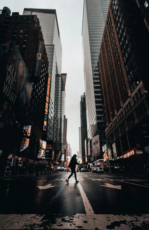 a person crossing a street in a big city