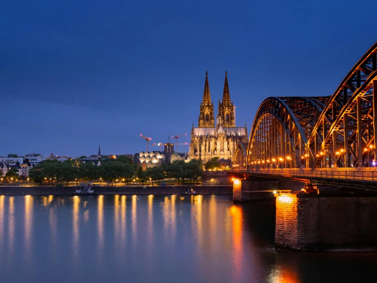 a bridge over water with an ornate tower in the background