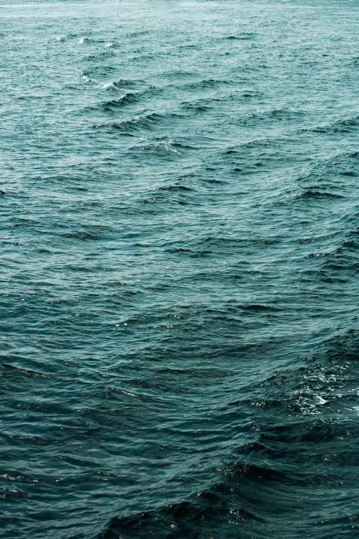 the surfboard is sitting on top of a big wavy ocean