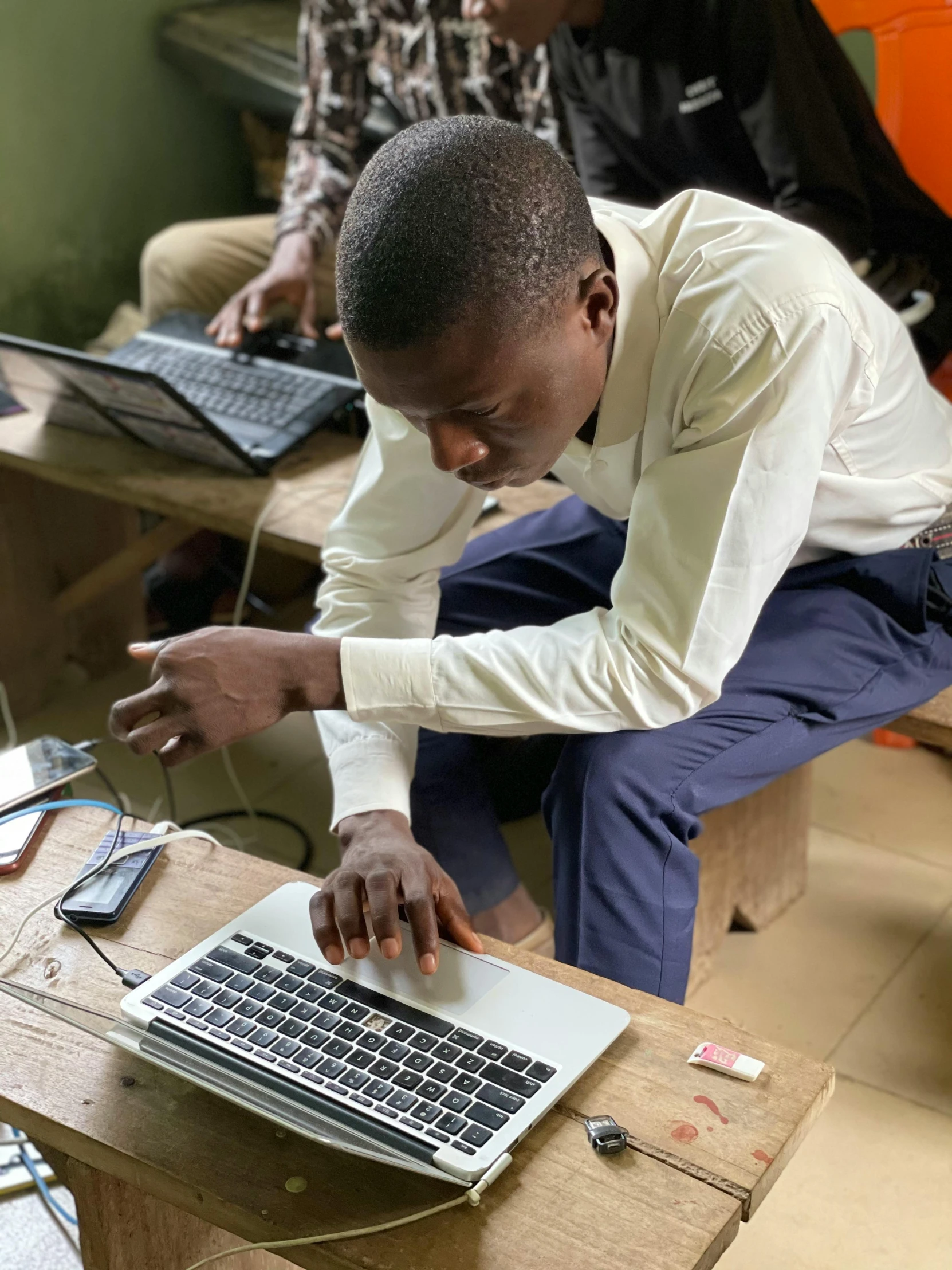 man doing soing on his laptop at the table