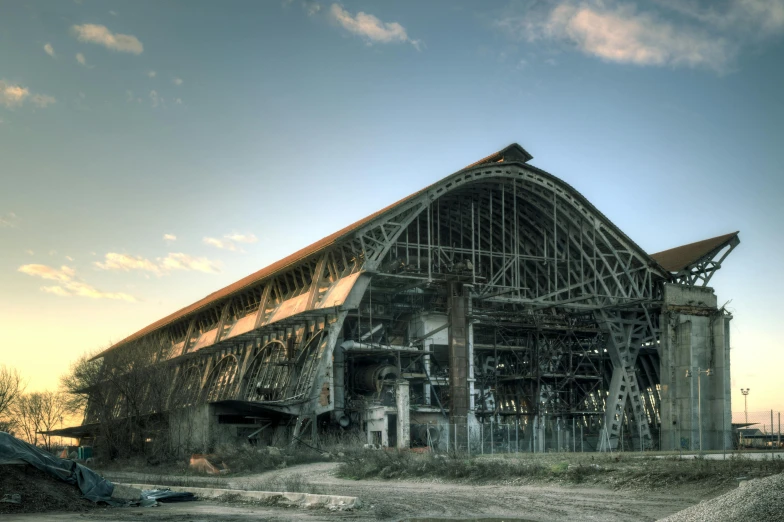 a huge train station sitting next to a dirt field