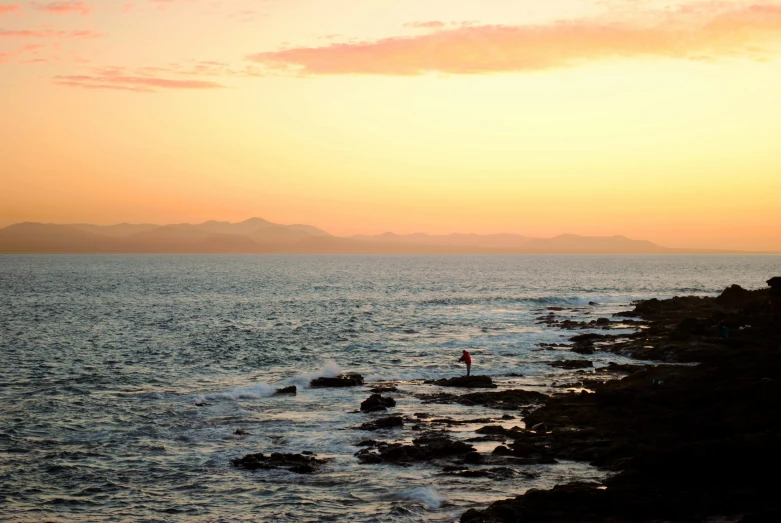 an image of some people standing at the edge of the water