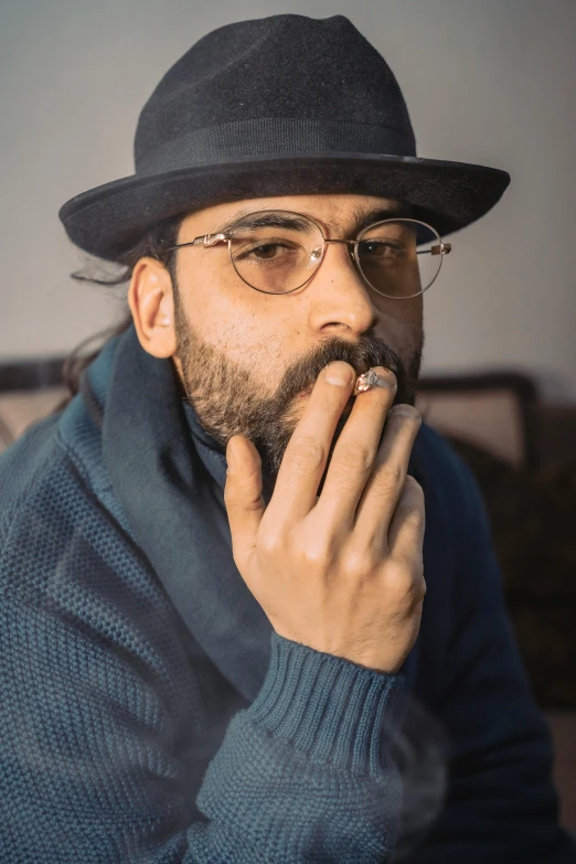 a man wearing a hat with glasses and a jacket