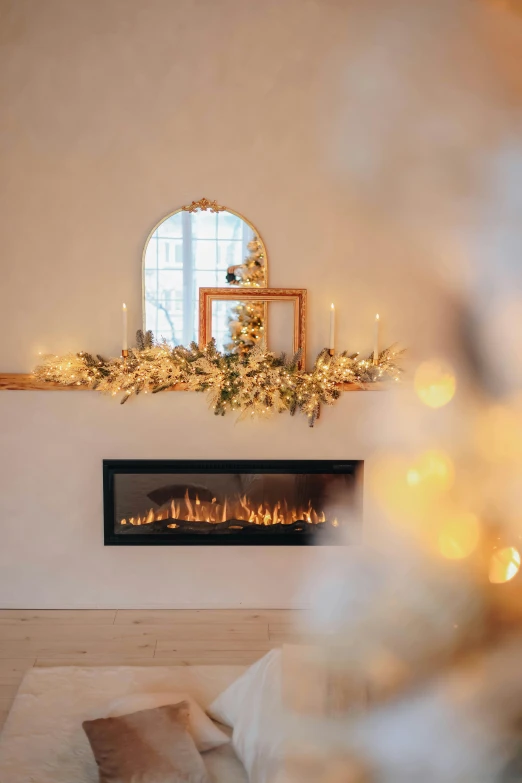 a fireplace is lit and surrounded by christmas lights