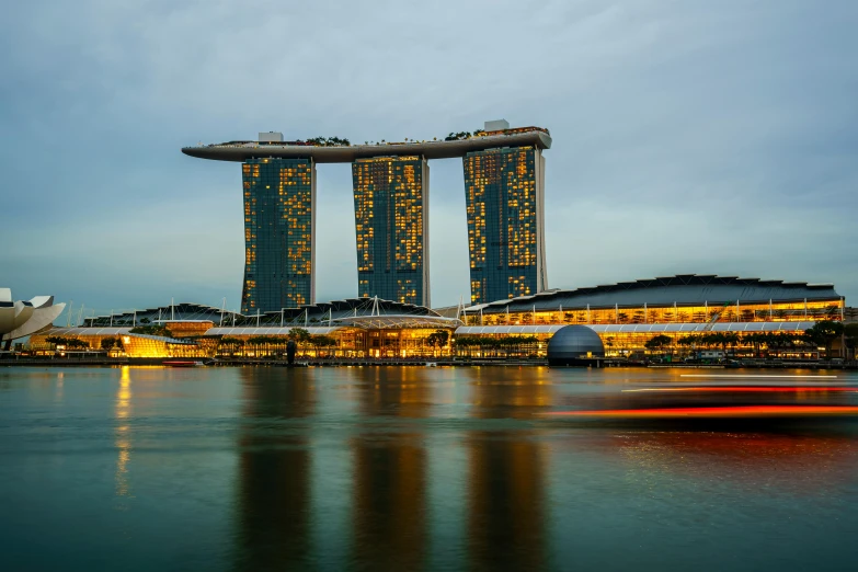 two tall buildings with some lights at the end