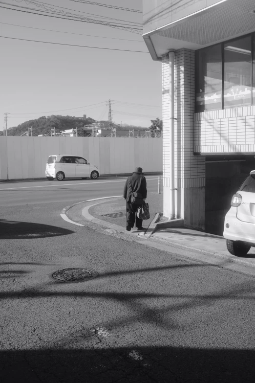 the man is standing next to his car