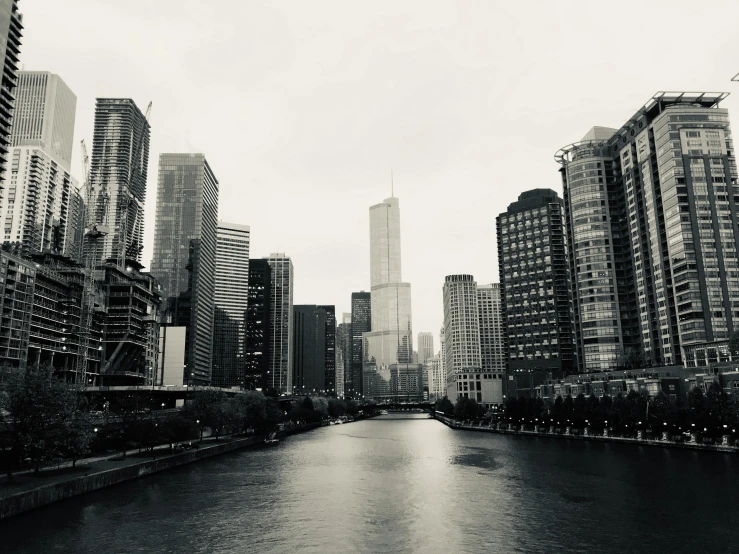 an empty waterway runs between tall city buildings