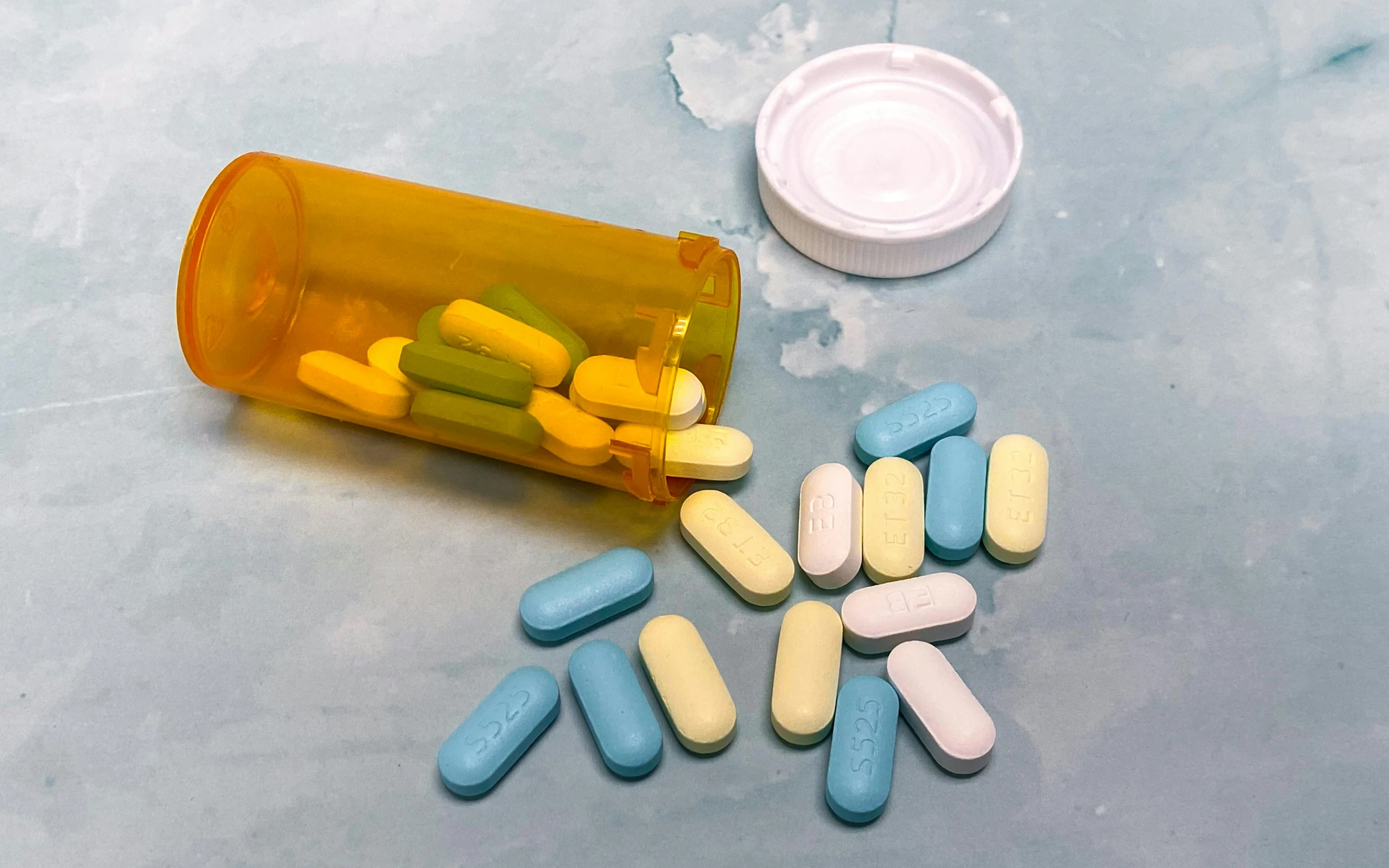 pills and an ivocal sit near a pill holder