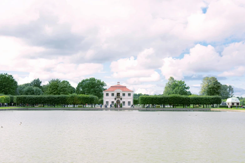 a po taken from the water looking across a pond with some trees