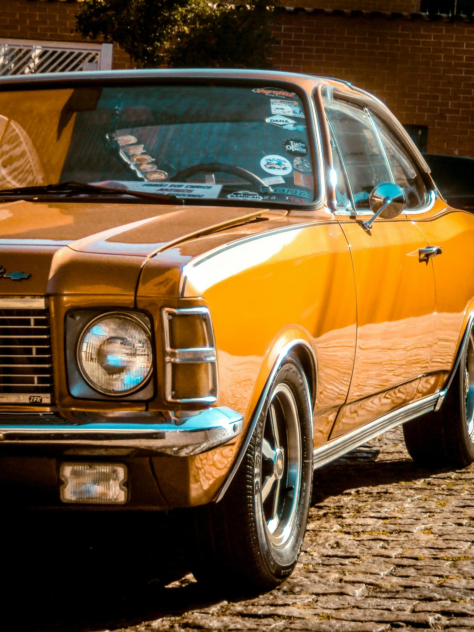 a vintage car on the side of the road with its hood open