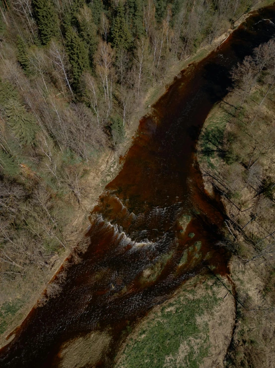 a view from above of a river with the ground covered in mud